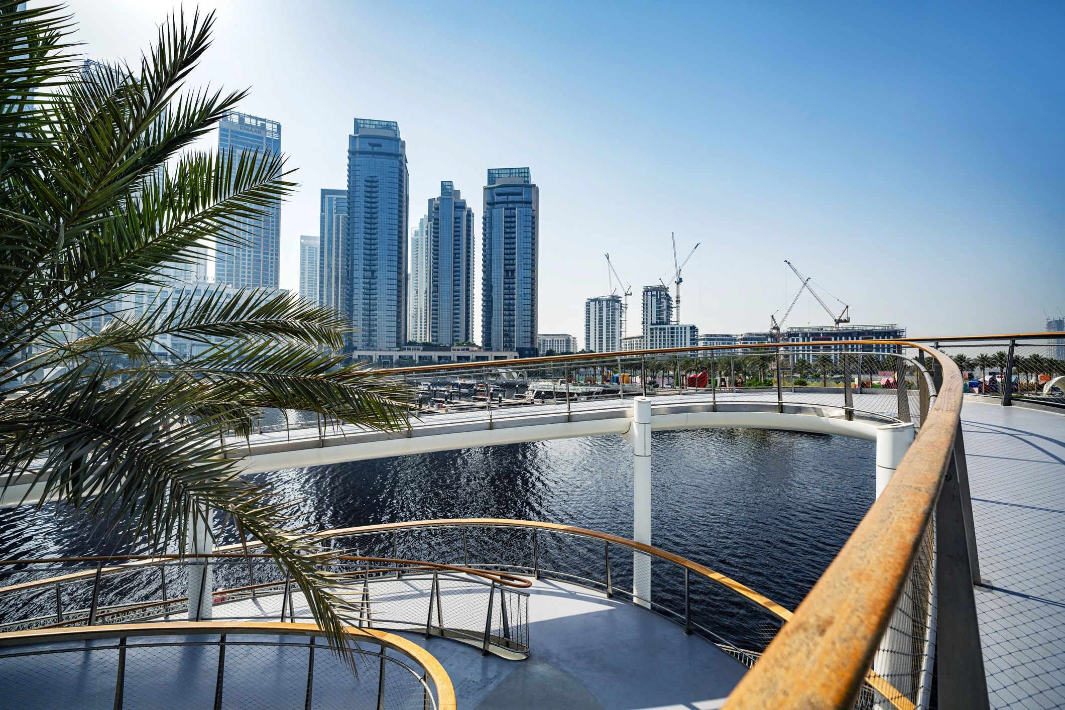 Dubai waterfront promenade with modern skyline and palm