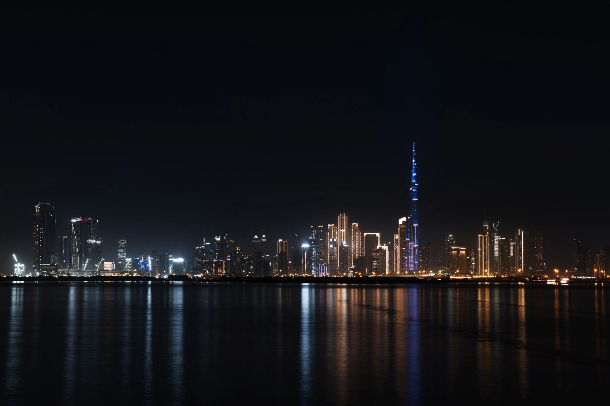 Dubai skyline reflected on the water at night